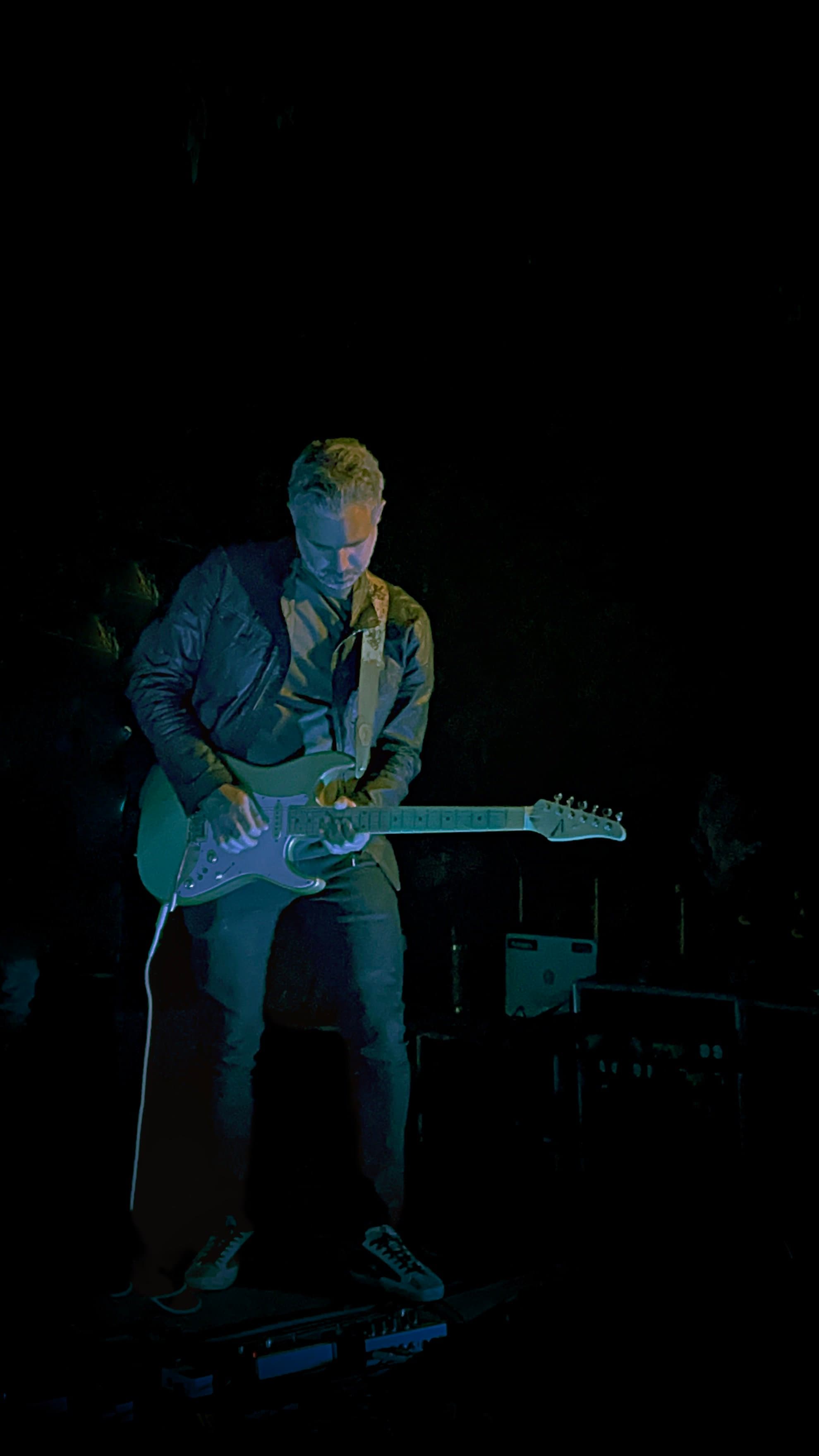Playing electric guitar on stage
